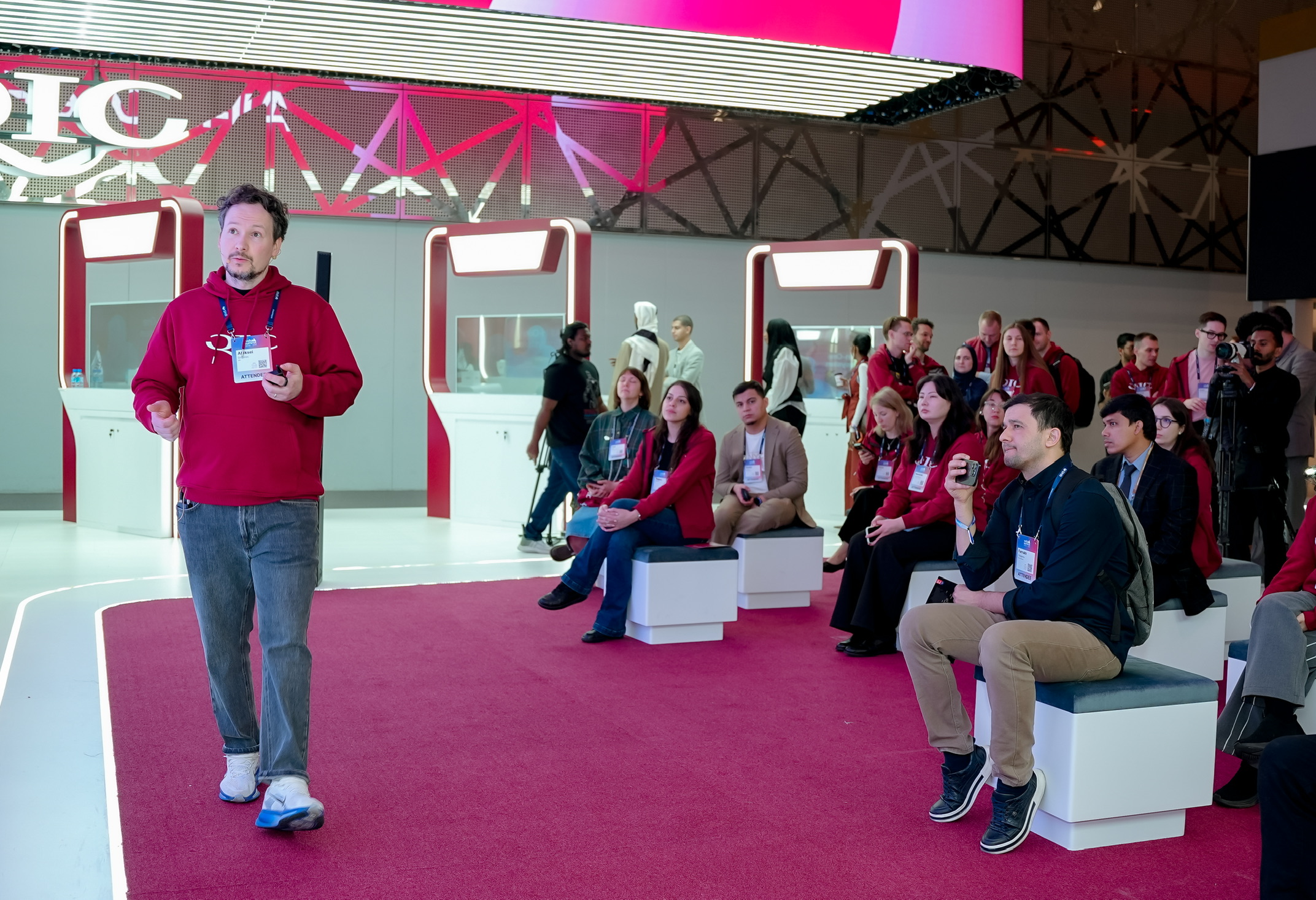 Aleksei Grigorev presenting to an audience at the QIC booth at Web Summit Qatar 2026